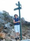 Ann at the sign where the trail branches off the Pipe Track